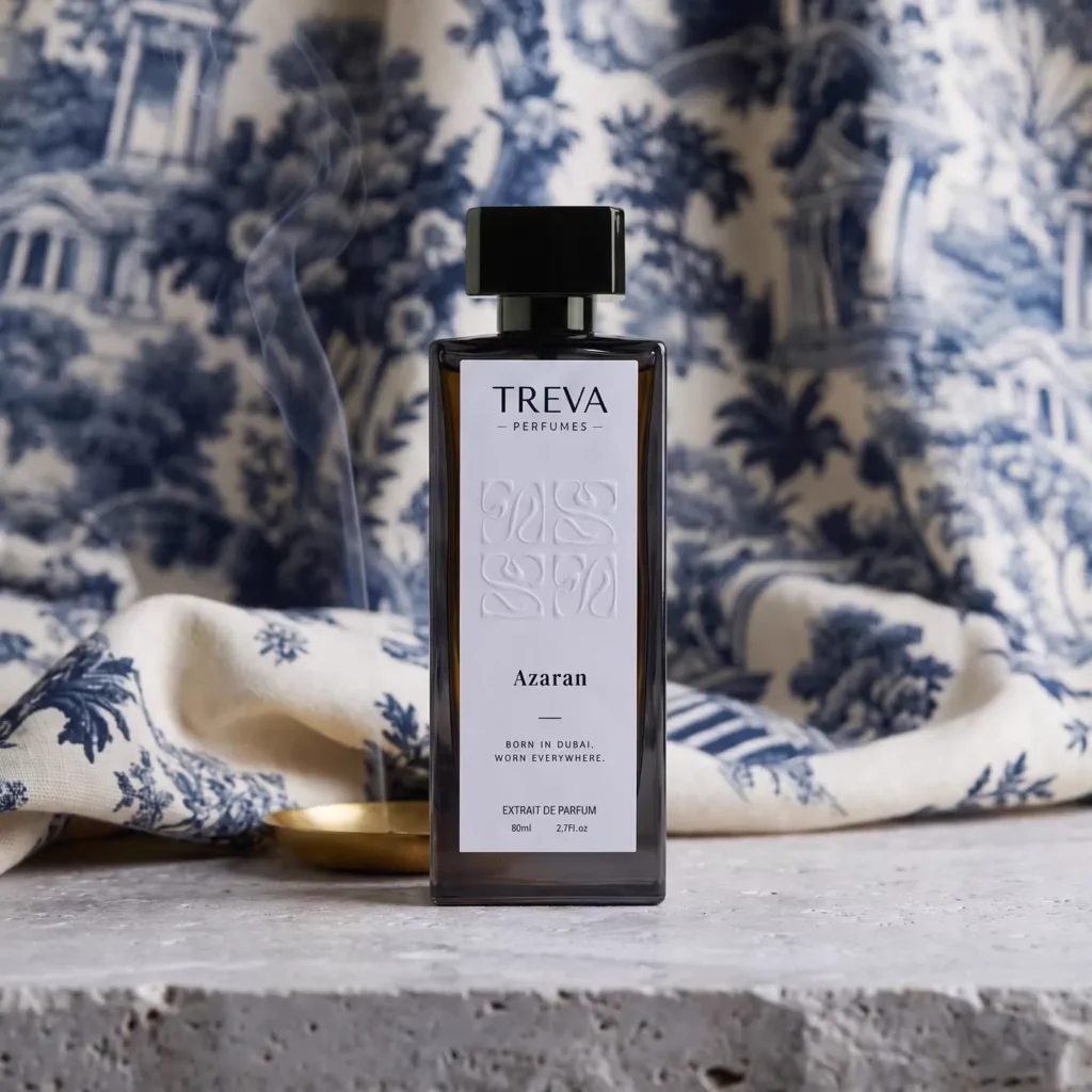 A Treva Azaran bottle in front of draped blue toile fabric, with a thin line of smoke rising